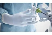 hand in Biogel glove holding monopolar scissors